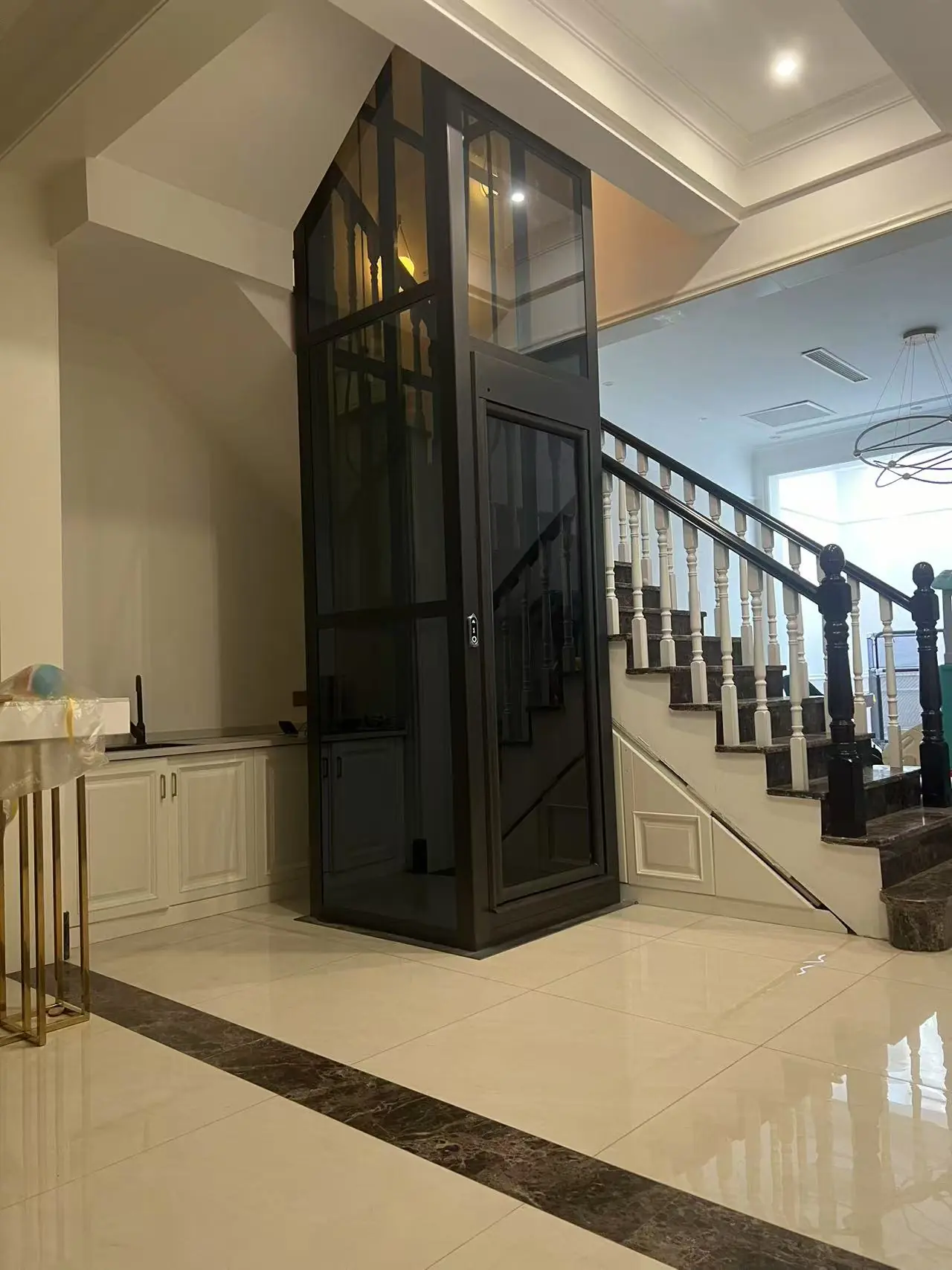 residential elevator manufacturer in china - villa home lift installed beside a staircase